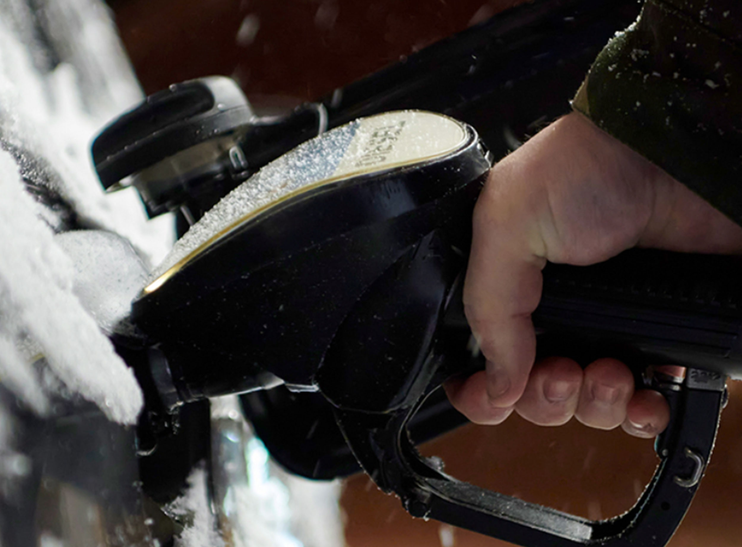 image of person pumping gas in cold weather