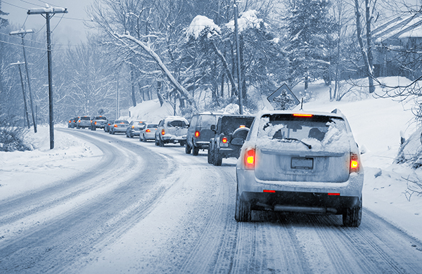 image of vehicles driving on snowy road