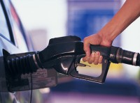 image of man's hand pumping gas into vehicle