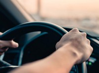 image of person with hands on steering wheel