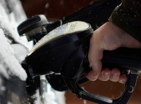 image of person pumping gas in cold weather