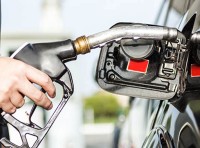 image of person pumping gas into vehicle