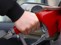 image of hand pumping gas into vehicle