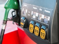 blurred image of gas pump with green handle